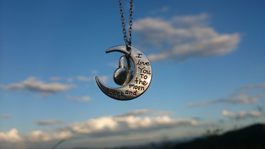 a heart and moon silver necklace with engraved words is a great push present