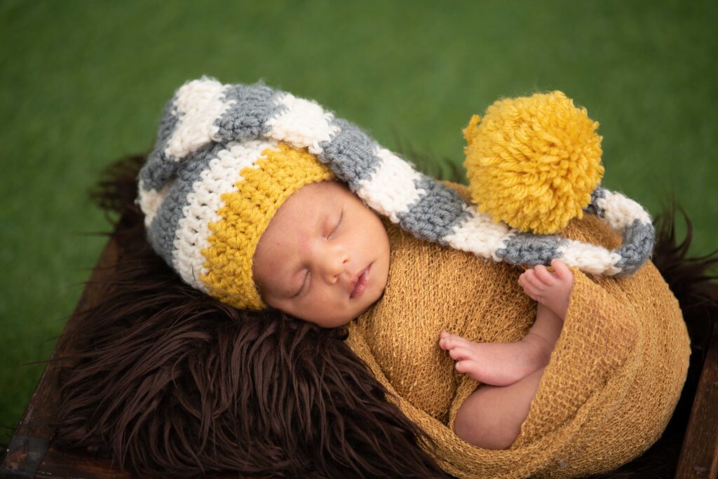 baby wrapped in yellow blanket