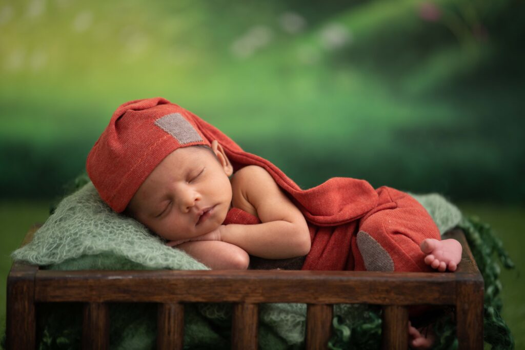 baby wrapped in red blanket